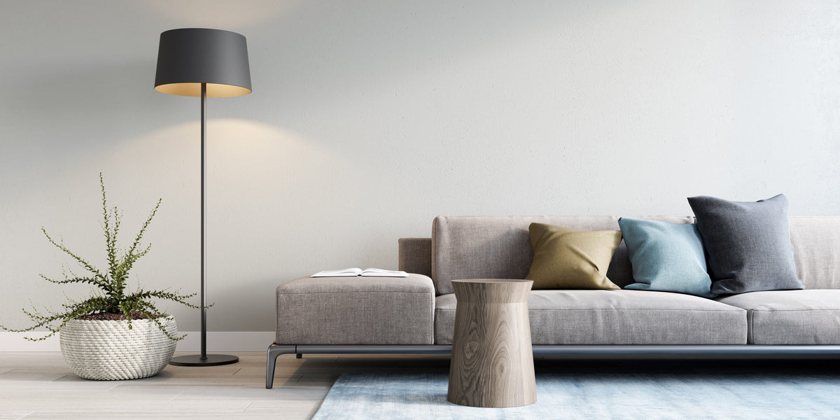 Modern floor lamp beside a gray sofa in a bright living room